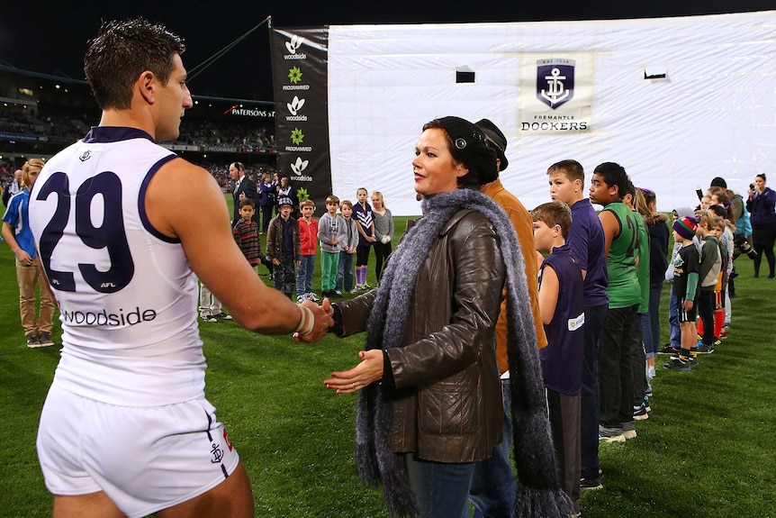 Matthew Pavlich of the Dockers greets Marite Norris, mother of MH17 crash victims Evie, Mo and Otis Maslin.