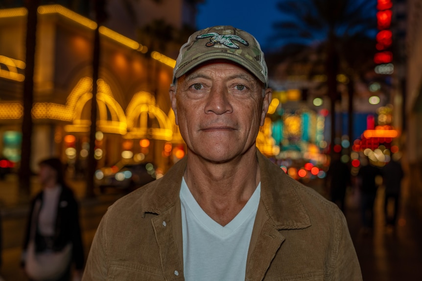 David Niu looks at the camera with the lights of Las Vegas's Fremont St behind him.