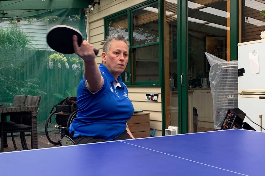 Danni is slightly blurred as she is in mid-motion after swinging her table tennis racquet