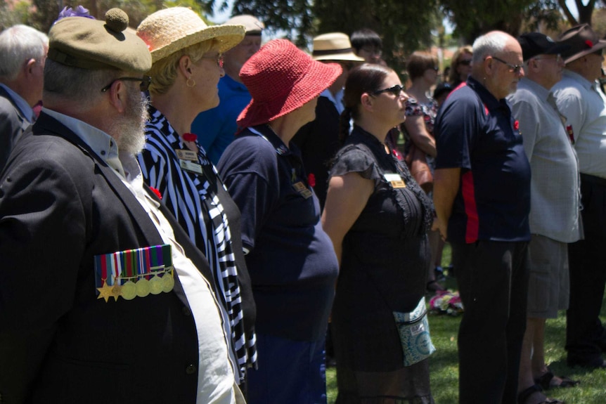 Crowds watch on during the Remembrance Day service at Loopline Park in Boulder.