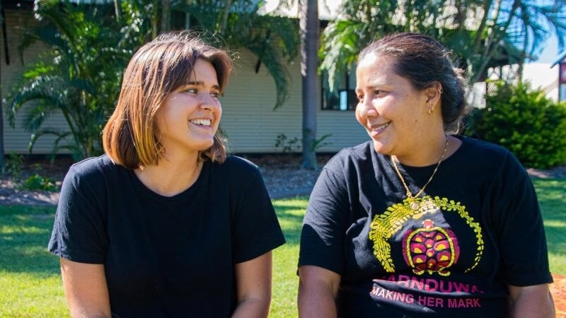 Friends Liv Trounce and Layla Yu smile at each other, friends who aren't afraid to talk about race and reconciliation.