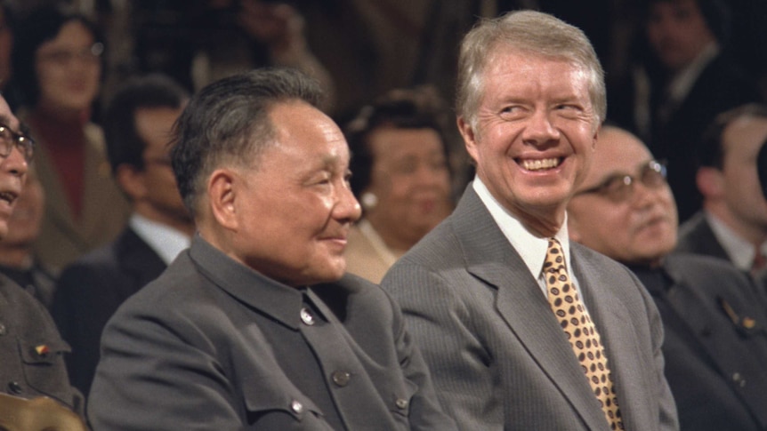 Jimmy Carter, right, sits next to Deng Xiaoping.