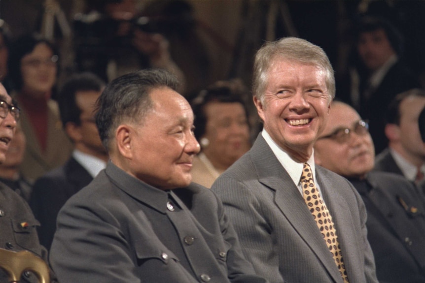 Jimmy Carter, right, sits next to Deng Xiaoping.