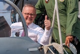 Anthony Albanese gives the thumbs up from the cockpit of a fighter jet