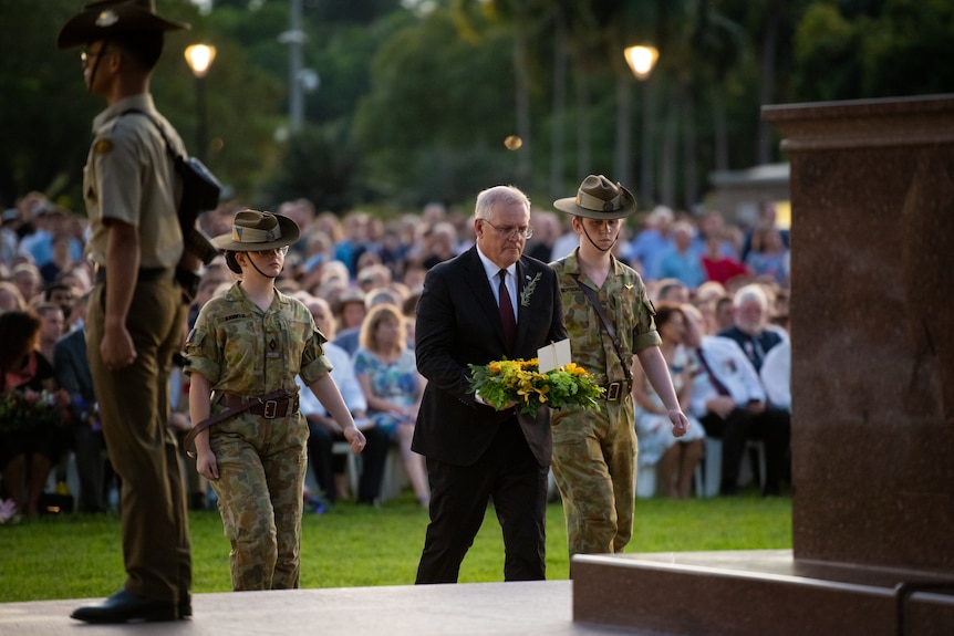 prime minister scott morrison holding a wreath