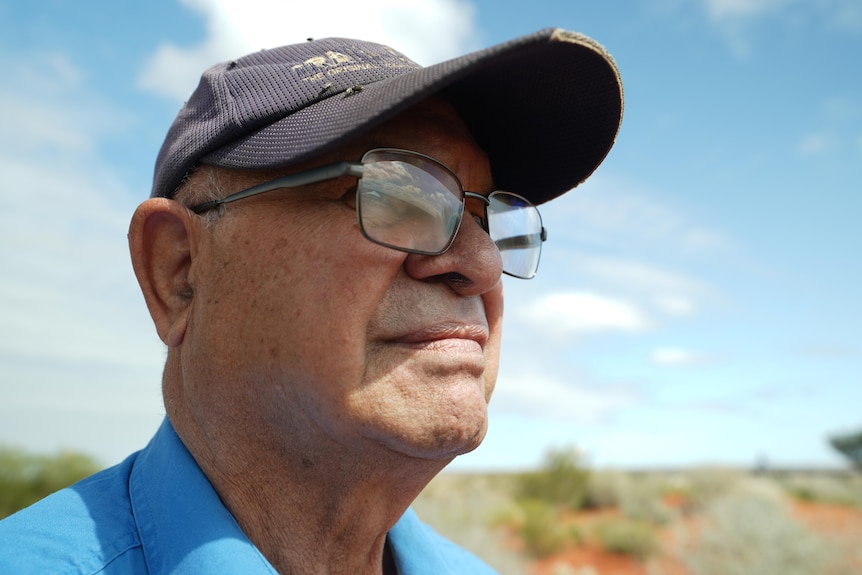 A close up photo of a Traditional Owner with glasses and a cap on