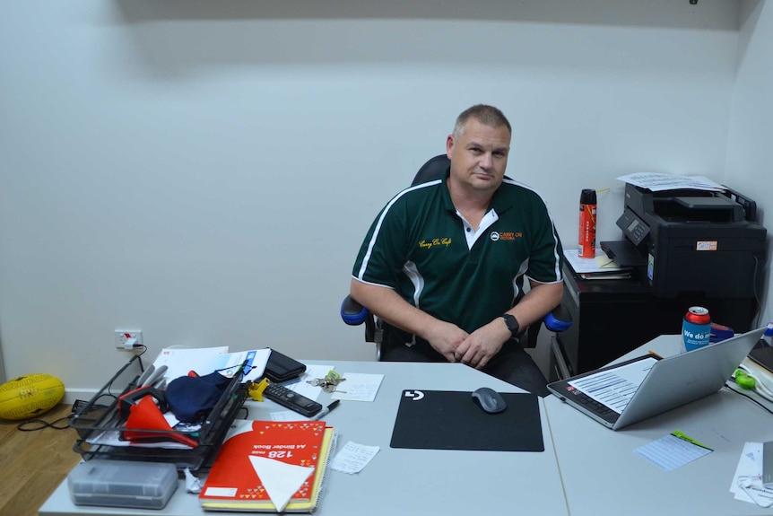 Criag Dekaste sitting in his office with his back to the wall