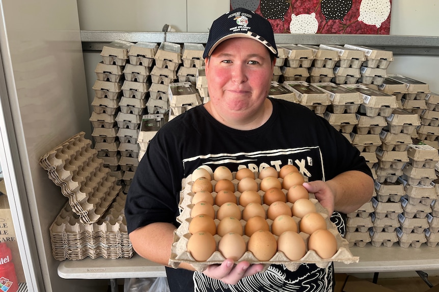 Amanda Doolan holds a tray full of eggs that have just been cleaned