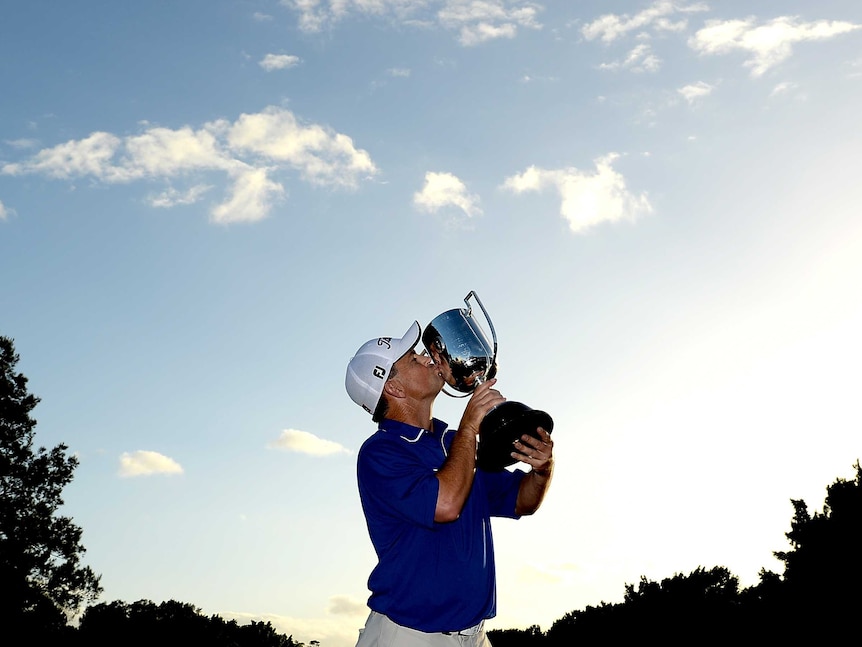 Greg Chalmers of Australia celebrates as he holds up the Kirkwood Cup after day four of the 2014 Australian PGA Championship at Royal Pines Resort