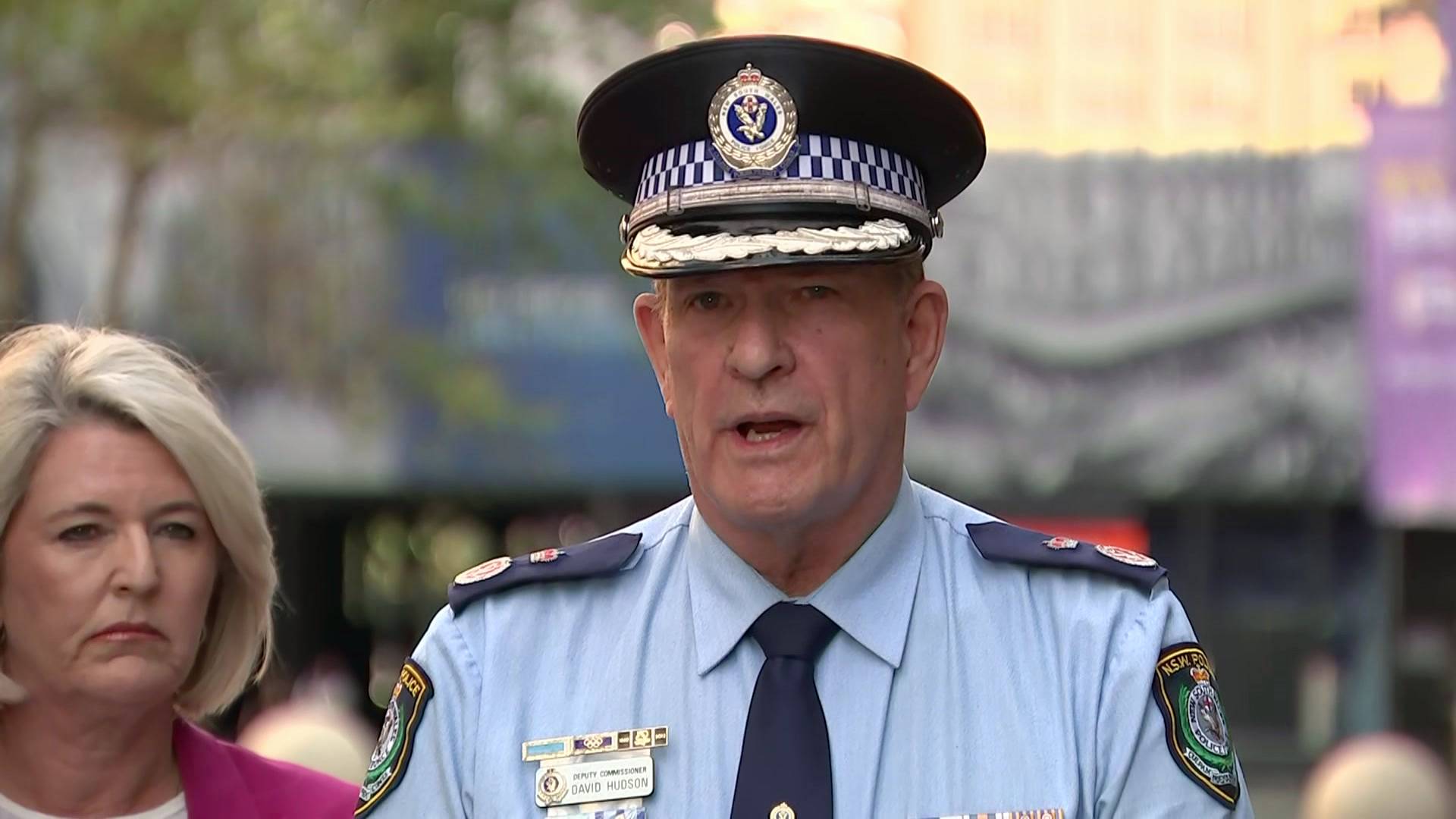 a senior police man standing outdoors and talking to the media
