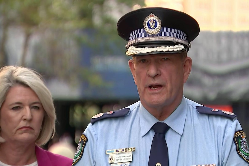 a senior police man standing outdoors and talking to the media