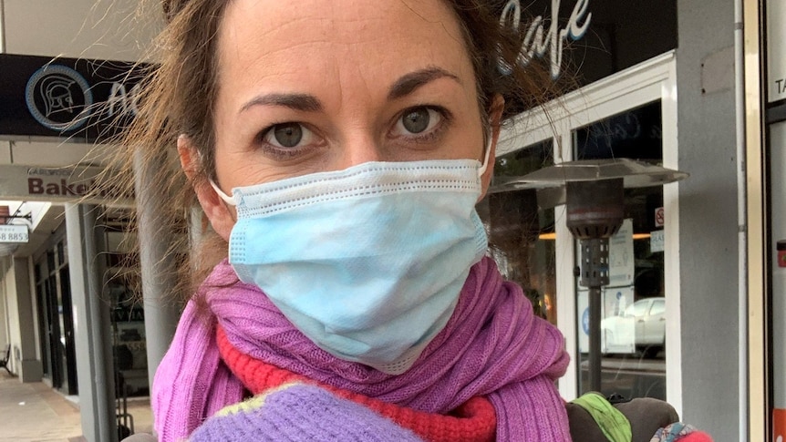 Close-up of a woman in a mask for a story on how to respond to the question 'what have you been up to?' during pandemic.