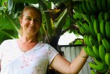 woman smiling next to bana tree