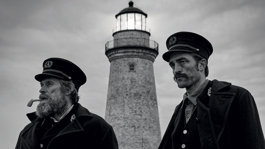 Black & white image from the movie the Lighthouse featuring Willem Dafoe and Robert Pattinson as two grizzly lighthouse keepers