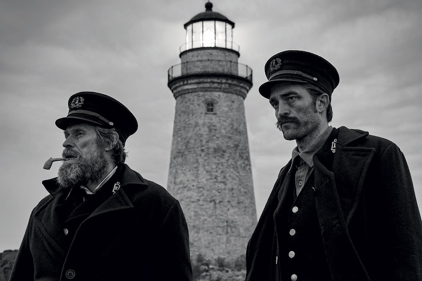 Black & white image from the movie the Lighthouse featuring Willem Dafoe and Robert Pattinson as two grizzly lighthouse keepers