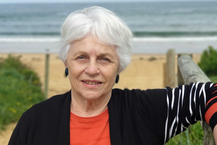 Rowena Turner stands at a beach.