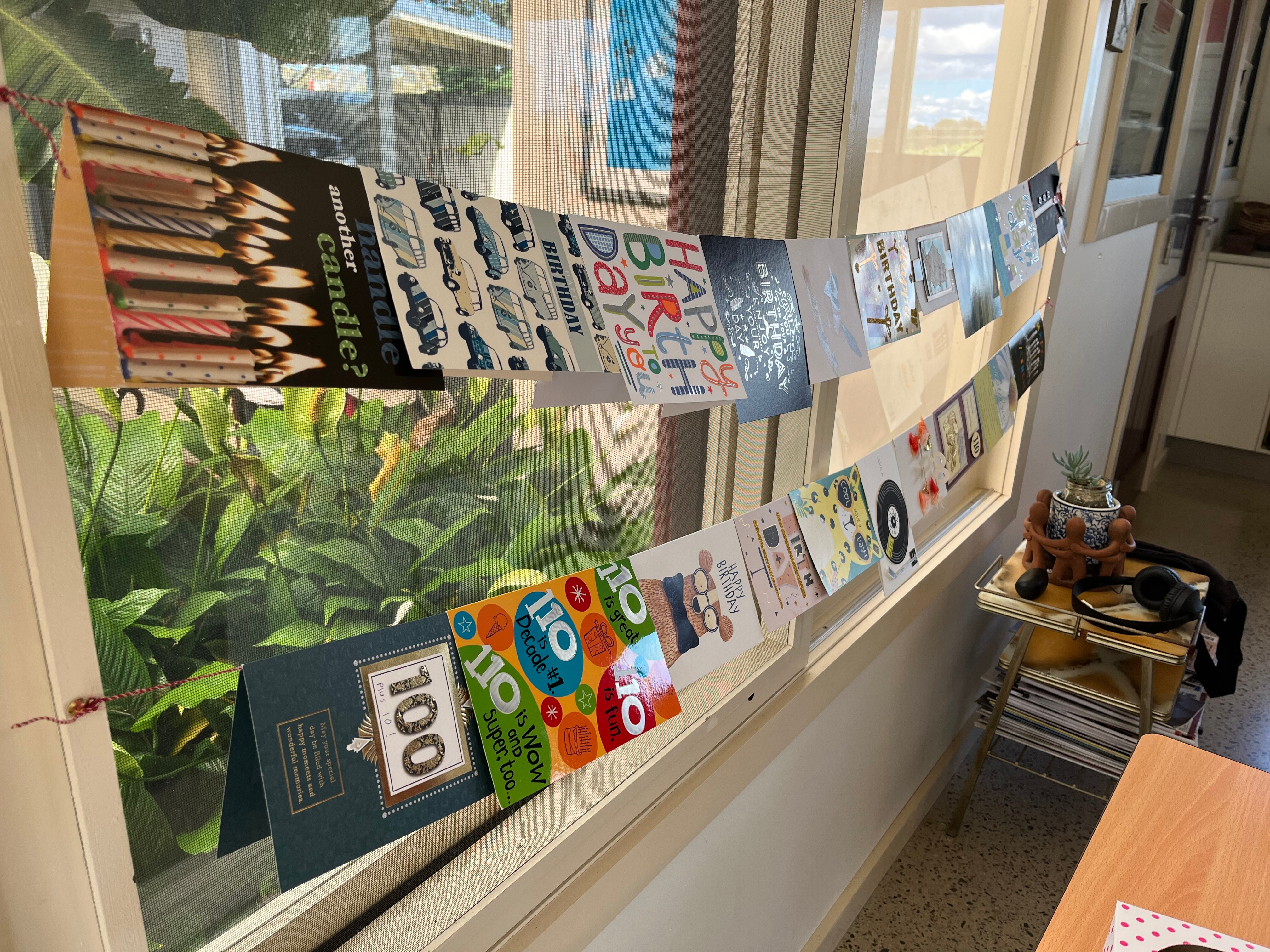 Birthday cards hung on string.