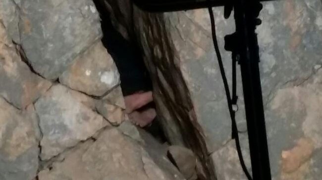 Feet of a 24-year-old climber wedged between two boulders at Mt Arapiles