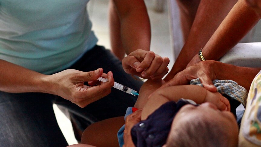 a child getting vaccination with a needle