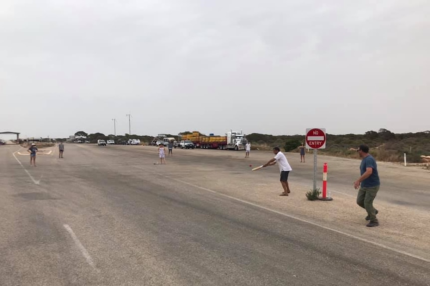 People playing cricket on the Eyre Highway.
