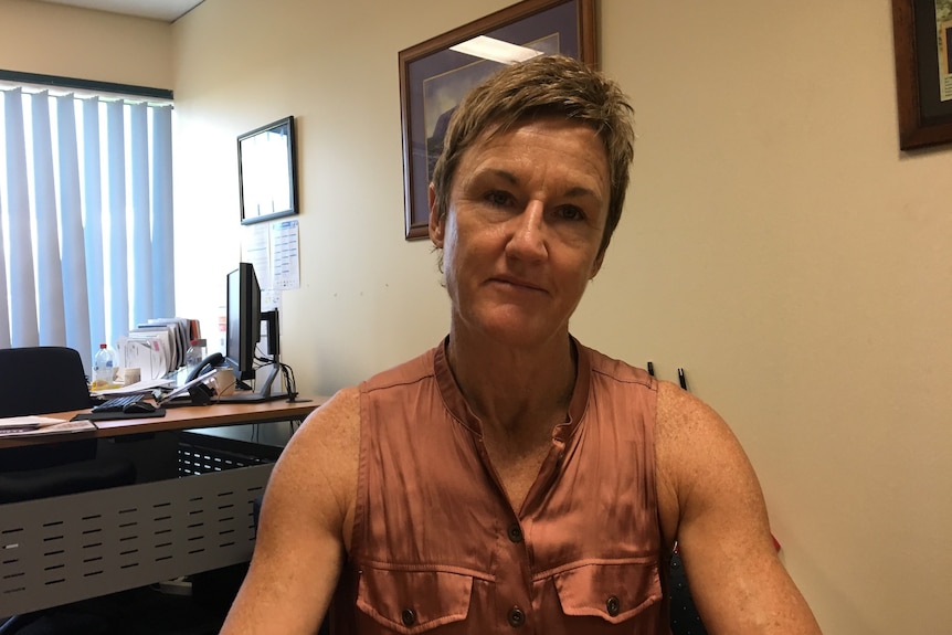 Colleen Gwynne sitting at a desk in her office