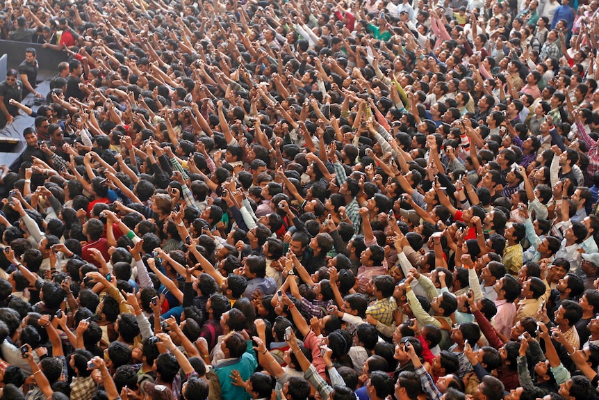 Fans hold up their phones to catch a glimpse of Shah Rukh Khan.