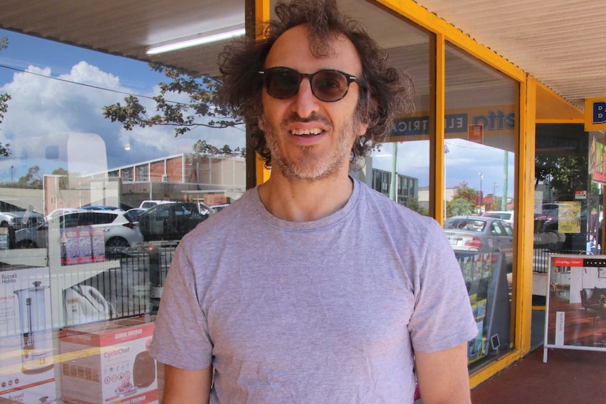 Darren Gross stands in front of a shop in Low Head.