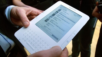 A man holding a Kindle e-reader (AFP: Mario Tama)
