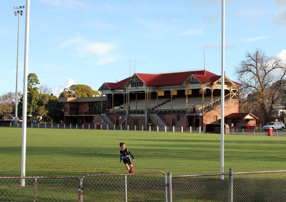 A boy kicks a ball at Princes Park in the Victorian town of Maryborough.