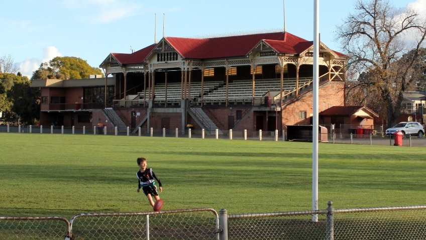 A boy kicks a ball at Princes Park in the Victorian town of Maryborough.