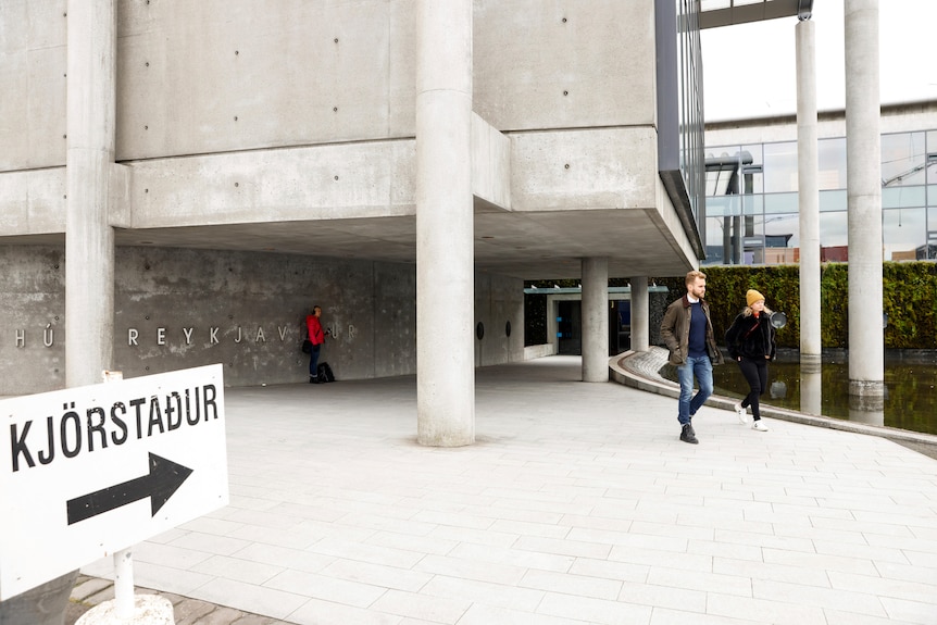 People walking outside a polling centre in Iceland.