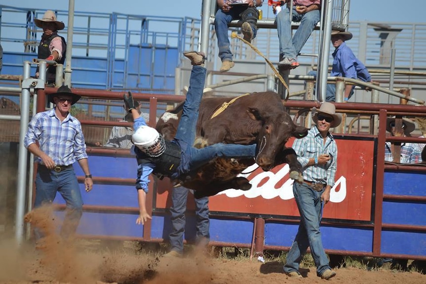 A teenager falls off his mount at the Tibooburra Rodeo
