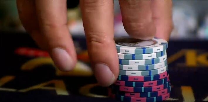 a person holding some casino chips