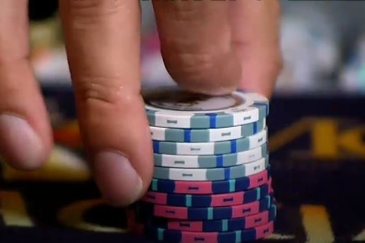 a person holding some casino chips