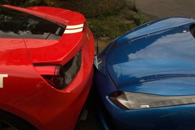 A shot of the red and blue Ferraris in the crash.