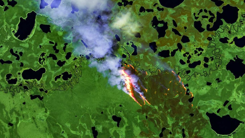 green satellite image with fire in the centre