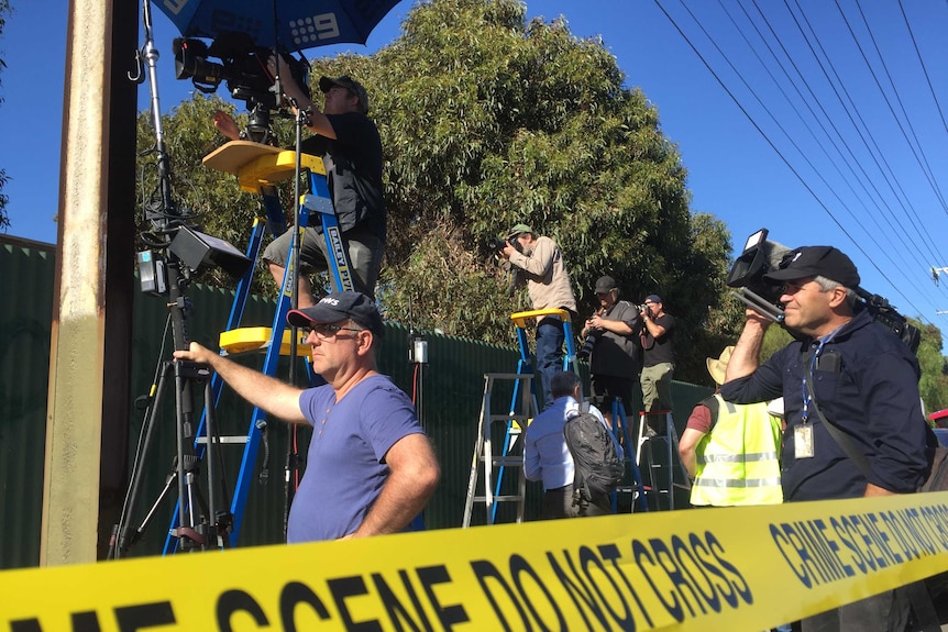 The media use ladders to see the excavation taking place at the New Castalloy factory in North Plympton.