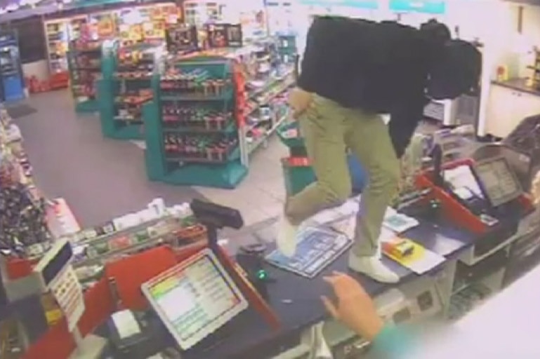 CCTV: Coulter used a tyre iron to threaten and attack an attendant at the Caltex service station in Kaleen.