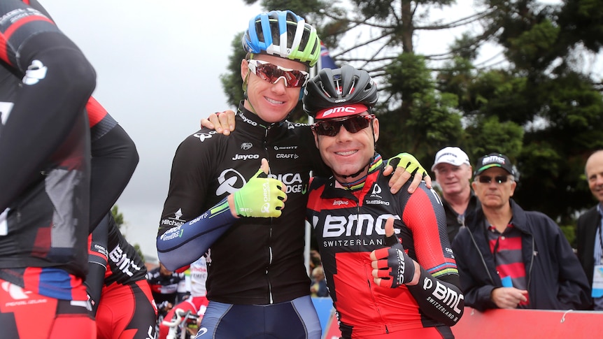 Two male cyclists pose for a photo