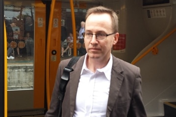 NSW Greens MP David Shoebridge gets off a train at Newcastle station.