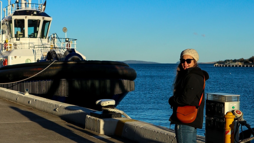Woman stands in front of Hobart harbour