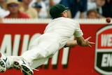 Glenn McGrath is horizontal in the air as the ball approaches his outstretched hands