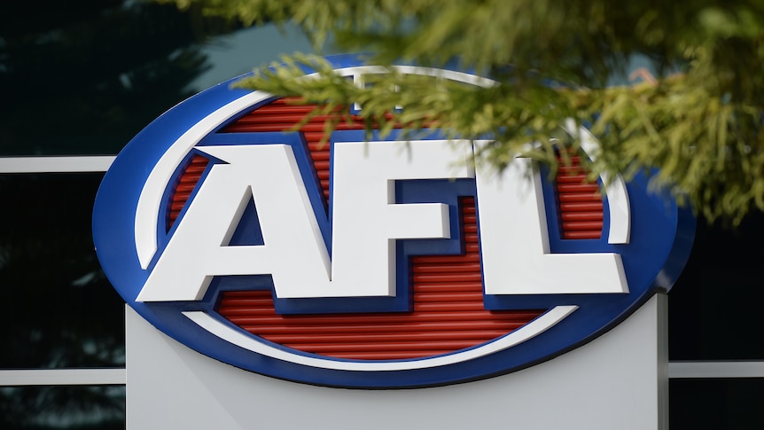 The AFL logo on the side of a building, partially obscured by a tree branch.