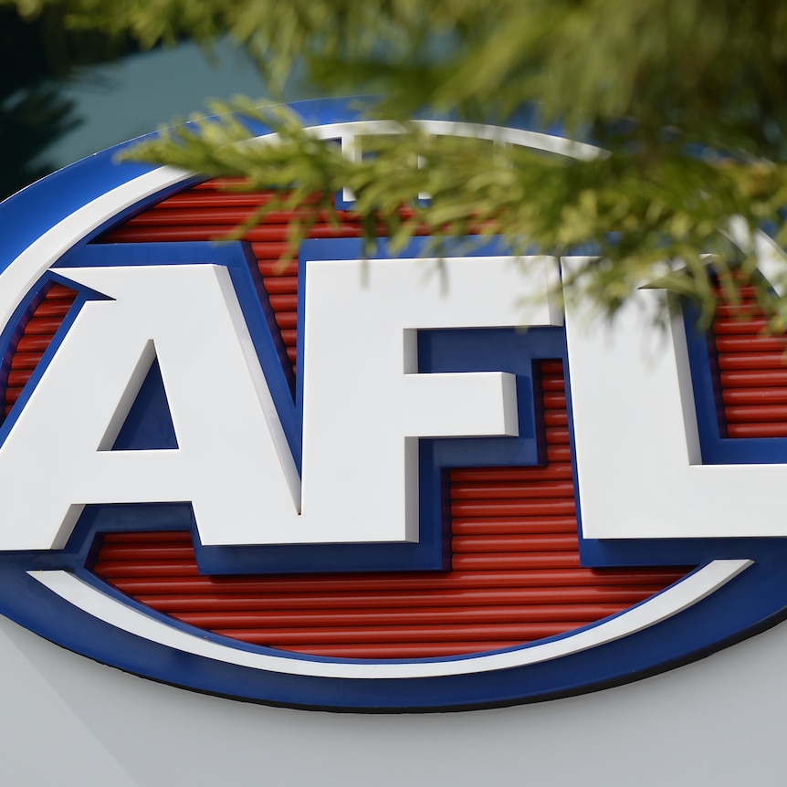 The AFL logo on the side of a building, partially obscured by a tree branch.
