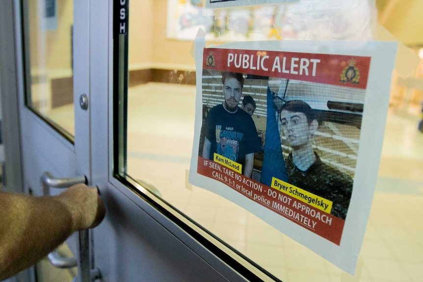 A wanted posted for the Canadian fugitives in a shop window