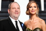 Hollywood producer Harvey Weinstein and wife fashion designer Georgina Chapman smile on the red carpet