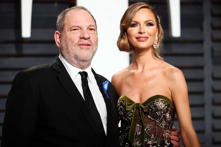 Hollywood producer Harvey Weinstein and wife fashion designer Georgina Chapman smile on the red carpet
