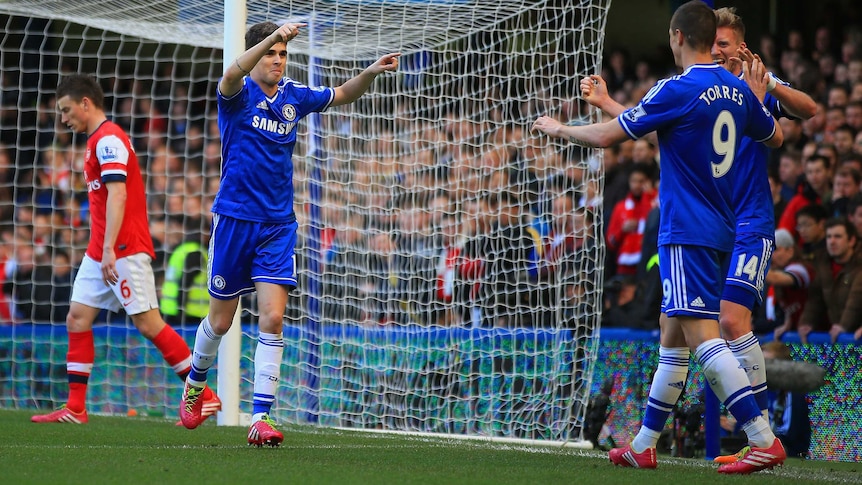 Chelsea's Oscar celebrates with team-mates after scoring his team's fourth goal against Arsenal.