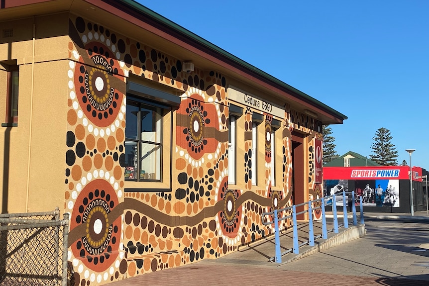 post office with aboriginal mural painted on the front