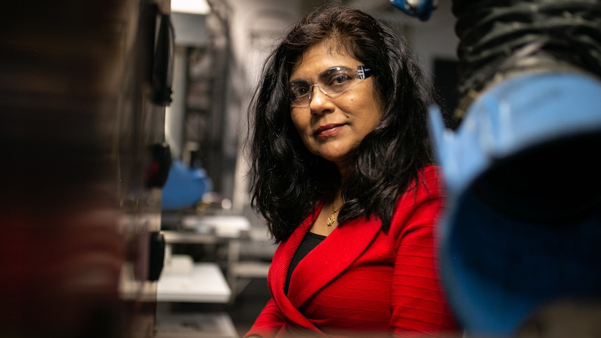 a woman wearing eye covering in a laboratory